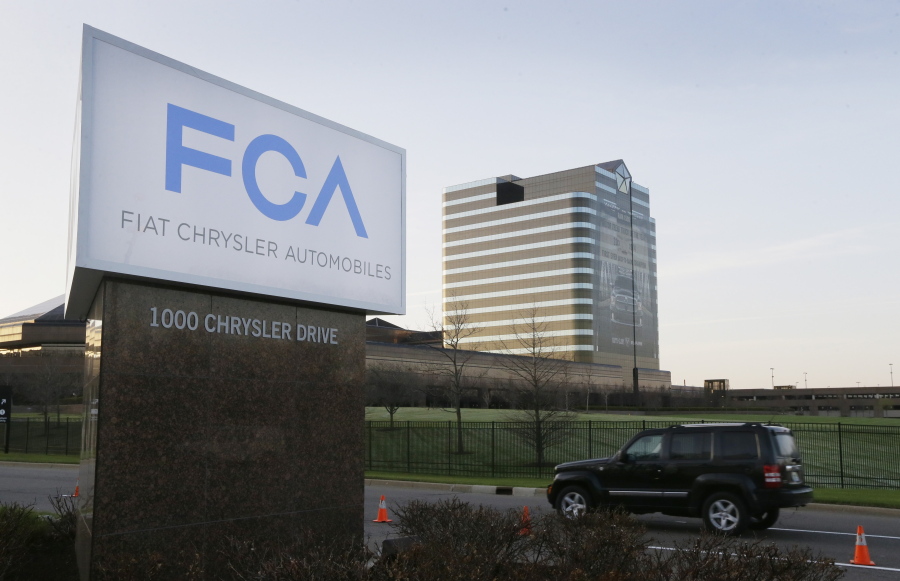 FILE - In this Tuesday, May 6, 2014, file photo, a vehicle moves past a sign outside Fiat Chrysler Automobiles world headquarters in Auburn Hills, Mich.  The European Union's top court has overturned a decision, Tuesday, Nov. 8, 2022,  requiring automaker Fiat Chrysler to pay up to 30 million euros ($30 million) in back taxes to Luxembourg. The European Commission, the EU's anti-trust regulator, had determined in 2015 that a Luxembourg tax ruling favored Fiat companies in Europe and was incompatible with state aid rules in the 27-nation bloc.
