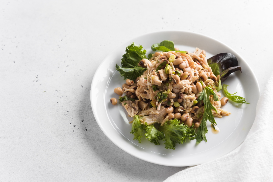 This image released by Milk Street shows a recipe for Chicken and Bean Salad with Pepper Jelly Vinaigrette.