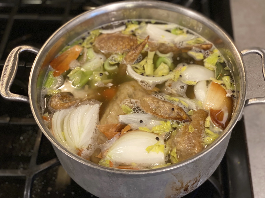 Vegetables and turkey parts cook on a stove to make turkey stock in New Milford, Conn.