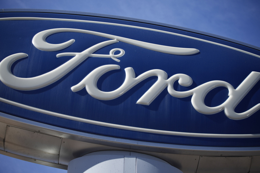 FILE - This Oct. 24, 2021 file photo shows a Ford company logo on a sign at a Ford dealership in southeast Denver.  Ford is recalling more than 550,00 F-150 vehicles in the U.S. and Canada, Friday, Nov. 18, 2022,  because the front windshield wiper motor may stop functioning, causing the wipers to stop working.
