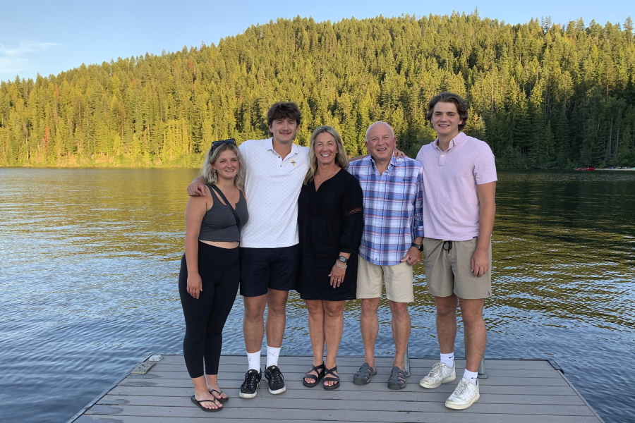 In this photo provided by Stacy Chapin, triplets Maizie, left, Ethan, second from left, and Hunter, right, pose with their parents Stacy and Jim Chapin at Priest Lake in northern Idaho in July 2022. Ethan Chapin was one of four University of Idaho students found stabbed to death in a home near the Moscow, Idaho campus on Sunday, Nov. 13, 2022.
