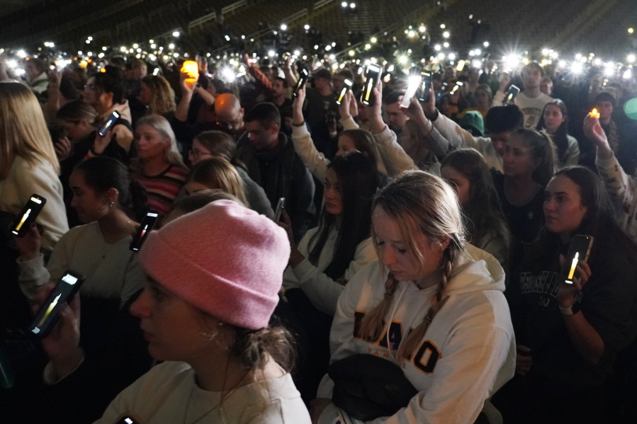 People at a vigil for the four University of Idaho students who were killed Nov. 13 hold up their lighted phones during a moment of silence Wednesday in Moscow, Idaho. (ted s.