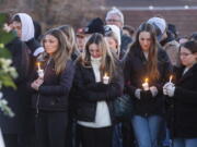 Boise State University students, along with people who knew the four University of Idaho students who were found killed in Moscow, Idaho, days earlier, pay their respects at a vigil held in front of a statue on the Boise State campus, Thursday, Nov. 17, 2022, in Boise, Idaho. Autopsies performed on the four students who were found dead inside a rental house near campus showed that all four were stabbed to death, the Latah County coroner said. (Sarah A.