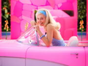 This image released by Warner Bros. Pictures shows Margo Robbie in character in the film "Barbie," releasing summer 2023. (Jaap Buitendijk/Warner Bros.