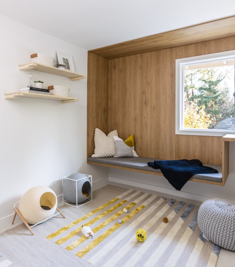 This image released by Anna Popov shows a spare room that was converted to a reading room with climbing shelves and cubbies for cats to enjoy in Redmond, Wash., designed by Anna Popov.