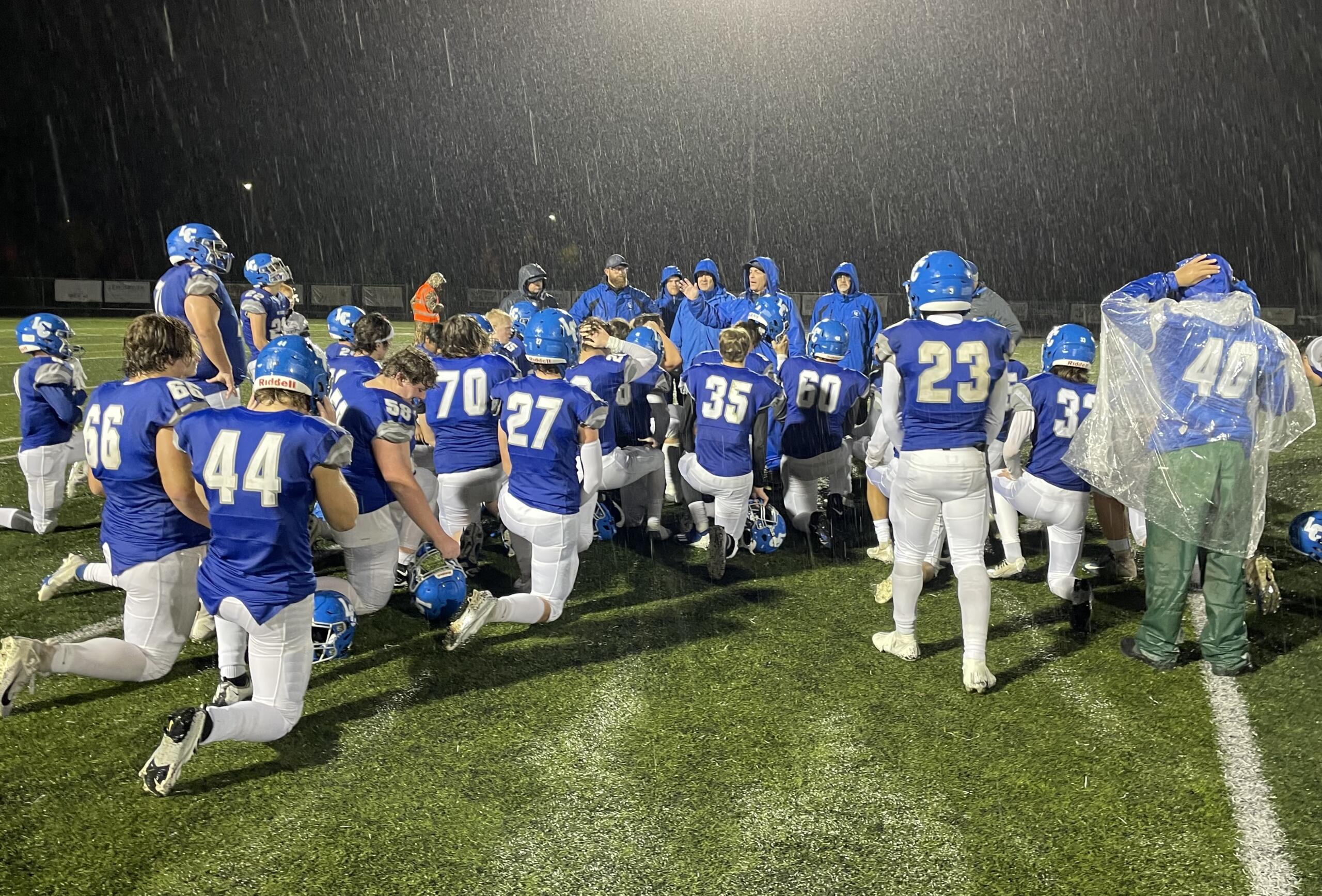 La Center head coach John Lambert addresses his team in the post-game huddle after the Wildcats' 63-14 win over Hoquiam in Week 10 on Nov. 4, 2022, at Woodland High School.