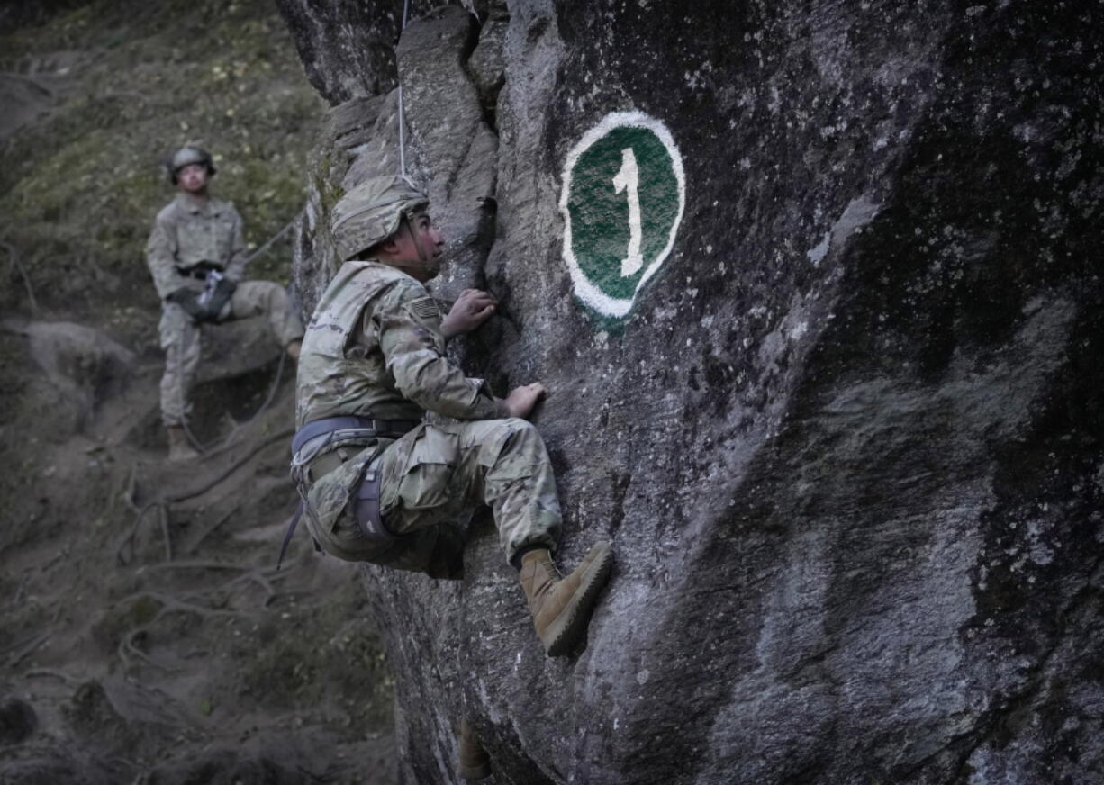 A US army soldier of 2nd Brigade of the 11th Airborne Division learns rock craft during Indo-US joint exercise or "Yudh Abhyas, in Auli, in the Indian state of Uttarakhand, Tuesday, Nov. 29, 2022. Militaries from India and the U.S. are taking part in a high-altitude training exercise in a cold, mountainous terrain close to India's disputed border with China. The training exercise began two weeks ago.