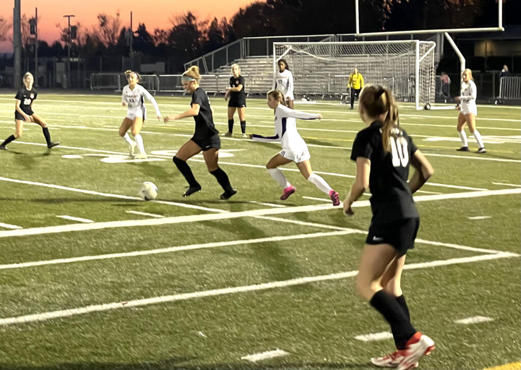 Camas sophomore Saige McCusker, center, looks to control the ball after a throw-in from teammate Abby Doyle, right, in a Class 4A state quarterfinal playoff game against Issaquah on Nov. 12, 2022, at Doc Harris Stadium in Camas.