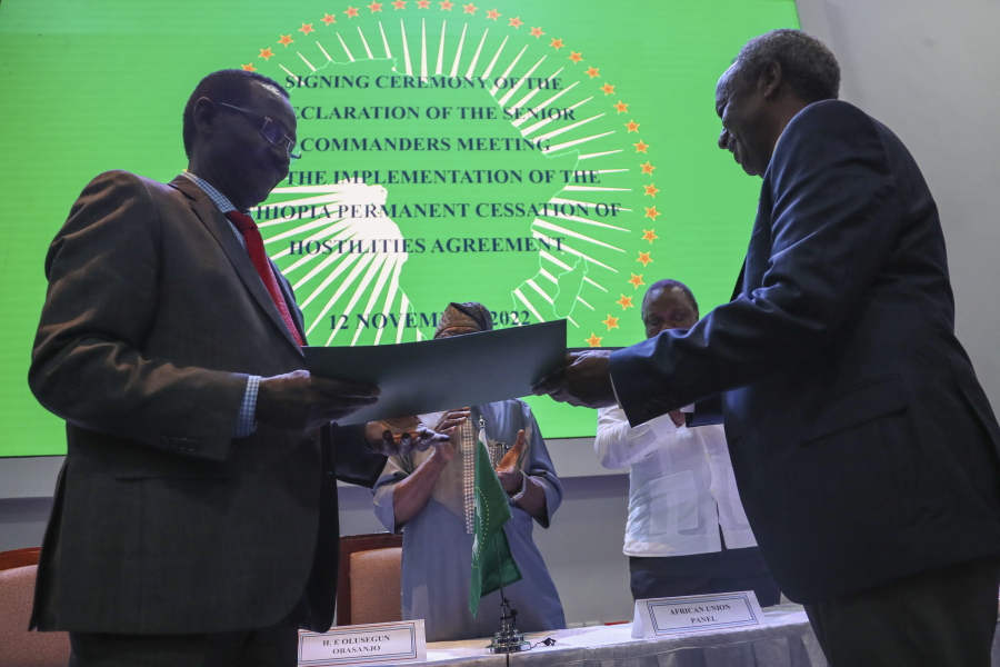 Chief of Staff of Ethiopian Armed Forces Field Marshall Birhanu Jula, left, and Head of the Tigray Forces Lieutenant General Tadesse Werede, right, exchange signed copies of an agreement, at Ethiopian peace talks in Nairobi, Kenya Saturday, Nov. 12, 2022.