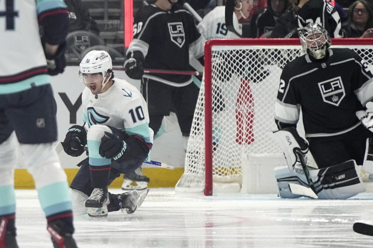 Seattle Kraken center Matty Beniers, left, celebrates his goal as Los Angeles Kings goaltender Jonathan Quick sits in goal during the second period of an NHL hockey game Tuesday, Nov. 29, 2022, in Los Angeles. (AP Photo/Mark J.