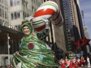 A parade performer in a Christmas Tree costume walks down Sixth Avenue during the Macy's Thanksgiving Day Parade, Thursday, Nov. 24, 2022, in New York.