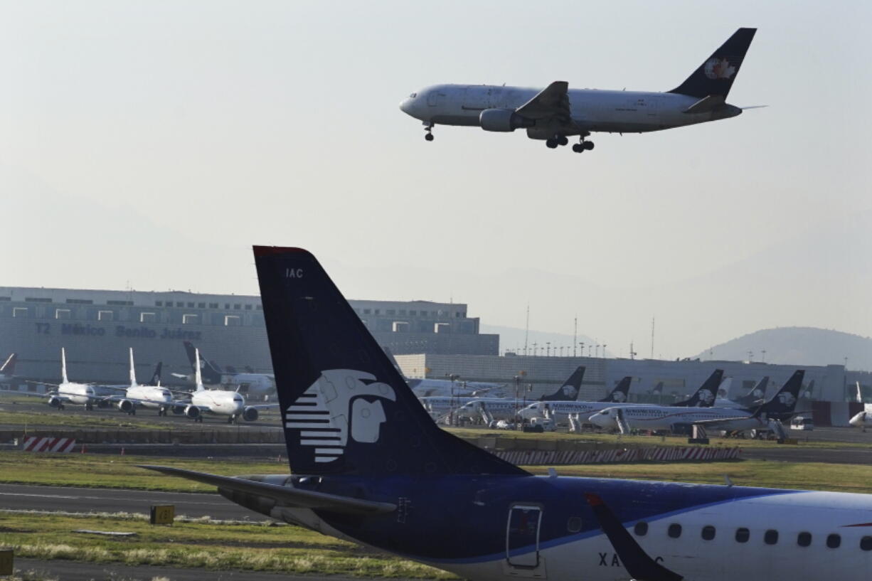 FILE - Passenger planes land at Benito Ju?rez International Airport in Mexico City, May 12, 2022.