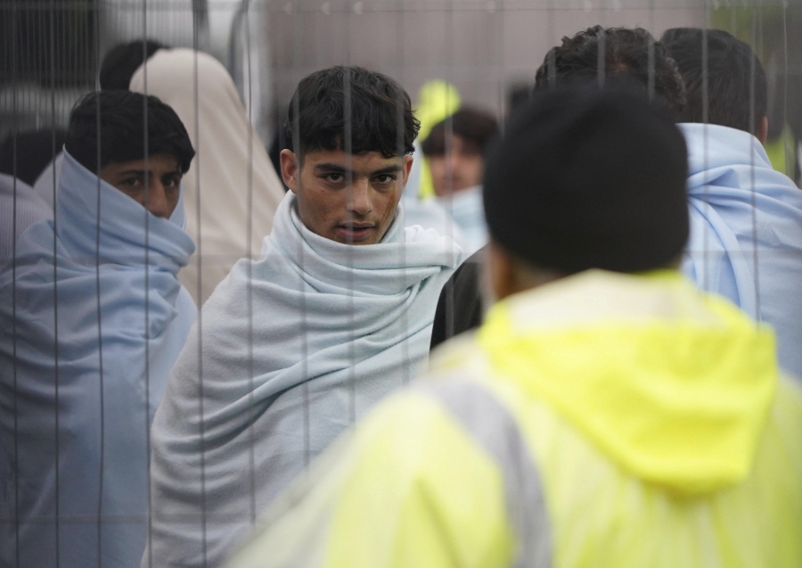 A view of people thought to be migrants inside the Manston immigration short-term holding facility located at the former Defence Fire Training and Development Centre in Thanet, Kent, England, Thursday, Nov. 3, 2022. Britain's interior minister has visited immigration facilities on England's southeastern coast as she grappled with an overcrowding crisis at a migrant facility and outcry over her claim that the U.K. faced an "invasion" of asylum-seekers.