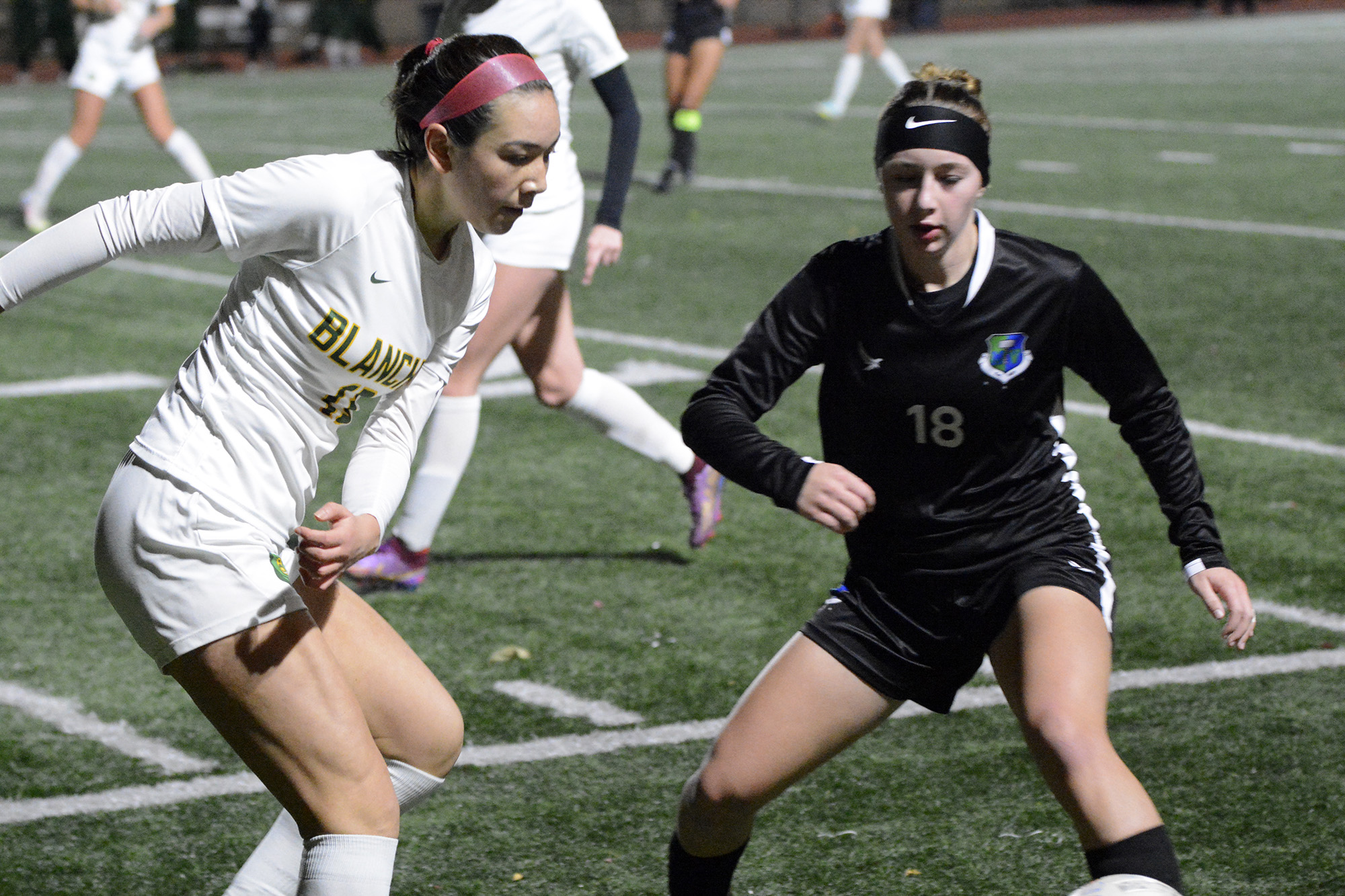 Bishop Blanchet's Kaya Hanson (left) and Mountain View's Teaghan Irvin battle for possession of the ball during a Class 3A girls soccer state round-of-20 match at McKenzie Stadium on Tuesday, Nov. 8, 2022.