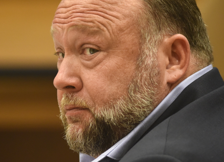 FILE - Infowars founder Alex Jones appears in court to testify during the Sandy Hook defamation damages trial at Connecticut Superior Court in Waterbury, Conn., on Thursday, Sept. 22, 2022. A six-person jury reached a verdict Wednesday, Oct. 12, 2022, saying that Jones should pay $965 million to 15 plaintiffs who suffered from his lies about the Sandy Hook school massacre. Jones and his company were found liable for damages last year.