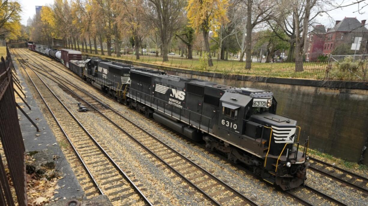 A Norfolk and Southern fright train makes it way through the Northside of Pittsburgh on Monday, Nov. 14, 2022. (AP Photo/Gene J.