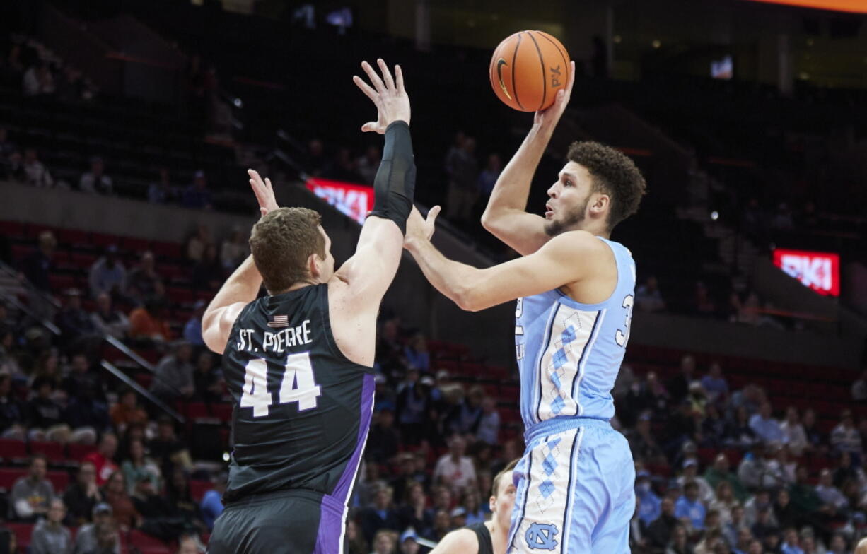 North Carolina forward Pete Nance, right, shoots over Portland center Joey St. Pierre during the first half of an NCAA college basketball game in the Phil Knight Invitational tournament in Portland, Ore., Thursday, Nov. 24, 2022.