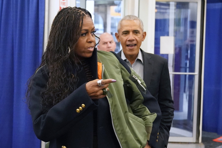 Former first lady Michelle Obama, left, and former President Barack Obama arrive to cast their ballots at an early voting site Oct. 17 in Chicago.