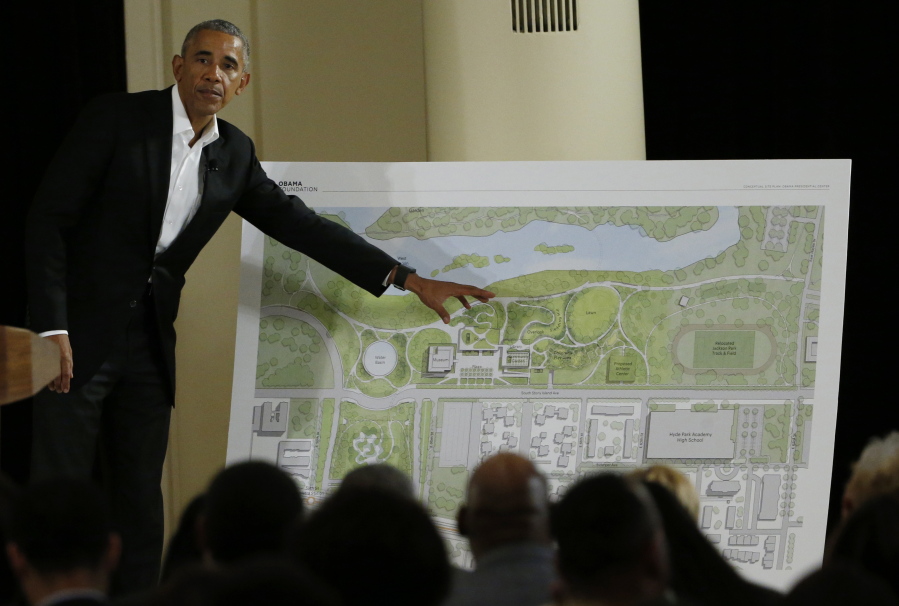 FILE - Former President Barack Obama points to a rendering for the former president's lakefront presidential center at a community event at the South Shore Cultural Center in Chicago on May 3, 2017. A federal judge on Tuesday, March 29, 2022, has dismissed a lawsuit that sought to prevent the construction of the Obama Presidential Center in a park on Chicago's South Side. (AP Photo/Nam Y.