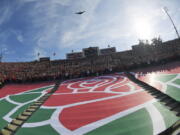 The Rose Bowl logo is seen during a fly over before the Rose Bowl NCAA college football game between Utah and Ohio State Saturday, Jan. 1, 2022, in Pasadena, Calif. Flipping the current college football playoff from four-teams to a 12-teams for the final two years of the current television contract will give those in charge of the postseason a look at how it works before committing to anything long term. But, The Granddaddy of Them All wants the CFP management committee to assure game organizers that their game will continue to be played annually on New Year's Day.  (AP Photo/Mark J.