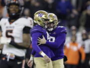 Washington placeholder Jack McCallister (38), right, congratulates place kicker Peyton Henry (47) kicking a field goal with eight seconds left on the clock against Oregon State during the second half of an NCAA collage football game, Friday, Nov. 4, 2022, in Seattle. Washington won 24-21.