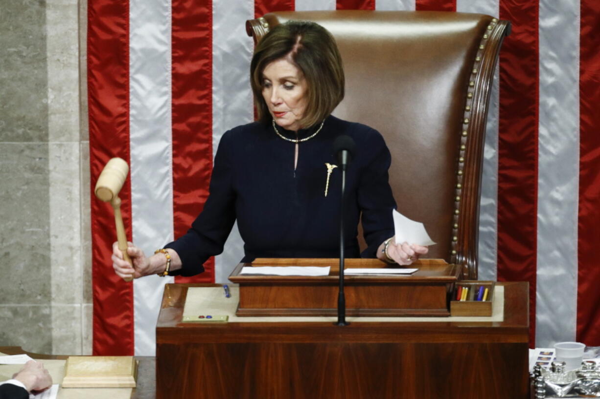 FILE - House Speaker Nancy Pelosi of Calif., strikes the gavel after announcing the passage of article II of impeachment against President Donald Trump, Dec. 18, 2019, on Capitol Hill in Washington.