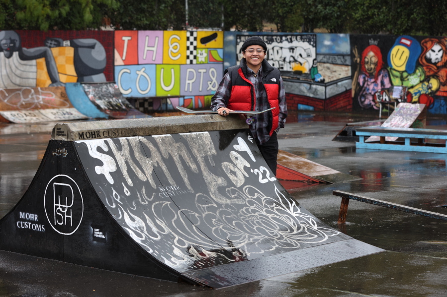 Sara Campos poses at tennis courts being converted to a skatepark at Portland State University in Portland, Ore., Friday, Oct. 28, 2022. Campos is a fellow in Tony Hawk's The Skatepark Project program, which is training 15 skateboarding enthusiasts in community organizing and project management so they can build a skatepark in their neighborhoods.
