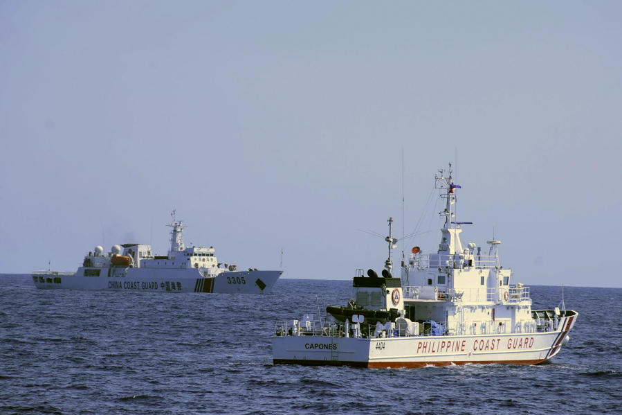 In this photo provided by the Philippine Coast Guard, a Chinese Coast Guard ship sails near a Philippine Coast Guard vessel during its patrol at Bajo de Masinloc, 124 nautical miles west of Zambales province, northwestern Philippines on March 2, 2022. The Philippines has sought an explanation from China after a Filipino military commander reported that the Chinese coast guard forcibly seized Chinese rocket debris in the possession of Filipino navy personnel in the disputed South China Sea, officials said Thursday, Nov. 24, 2022.