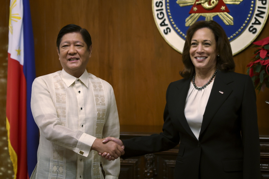U.S. Vice President Kamala Harris, right, shakes hands with Philippine President Ferdinand Marcos Jr. at the Malacanang presidential palace in Manila, Philippines Monday, Nov.