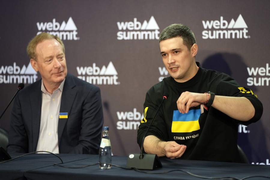 Ukraine's Minister of Digital Transformation Mykhailo Fedorov gestures during a joint news conference with President and Vice Chairman of Microsoft Brad Smith, left, at the Web Summit technology conference in Lisbon, Portugal, Thursday, Nov. 3, 2022.