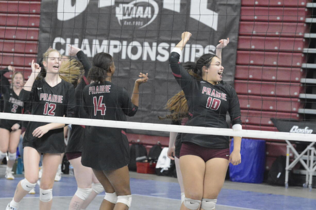 Prairie volleyball players Claire Neuman (12), Diamond Doutrive (14) and Kuulei DeBest (10) celebrate after an ace against Seattle Prep at the Class 3A state volleyball tournament on Thursday, Nov. 17, 2022 in Yakima.