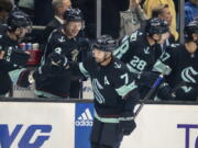 Seattle Kraken forward Jordan Eberle is congratulated by teammates on the bench after scoring a goal against the Nashville Predators during the first period of an NHL hockey game, Tuesday, Nov. 8, 2022, in Seattle.