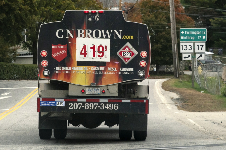 FILE - A fuel delivery truck advertises its price for a gallon of heating oil, Oct. 5, 2022 in Livermore Falls, Maine. The Labor Department releases the Producer Price Index for October on Tuesday. (AP Photo/Robert F.