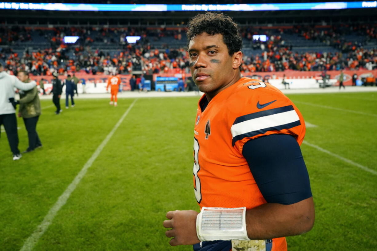 Denver Broncos quarterback Russell Wilson walks off the field after an NFL football game against the Las Vegas Raiders in Denver, Sunday, Nov. 20, 2022. The Raiders won 22-16 in overtime.