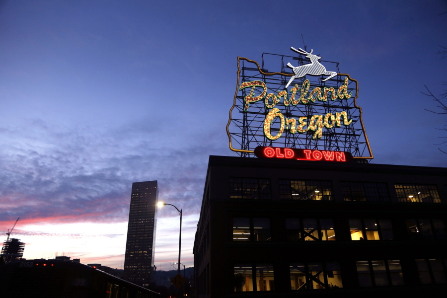 FILE - The "Portland, Oregon" sign is seen atop in building in downtown Portland, Ore., on Jan. 27, 2015. Residents of Portland will vote on a ballot measure next week that would completely overhaul the way City Hall works, amid growing voter frustration over surging homelessness and crime. It would scrap the city's unusual commission form of government and implement a rare form of ranked choice voting not used in any other U.S. city.