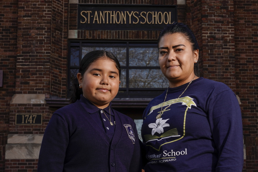 Lorena Ramirez stands with her daughter Citlalli outside St. Anthony School on Oct. 20 in Milwaukee.