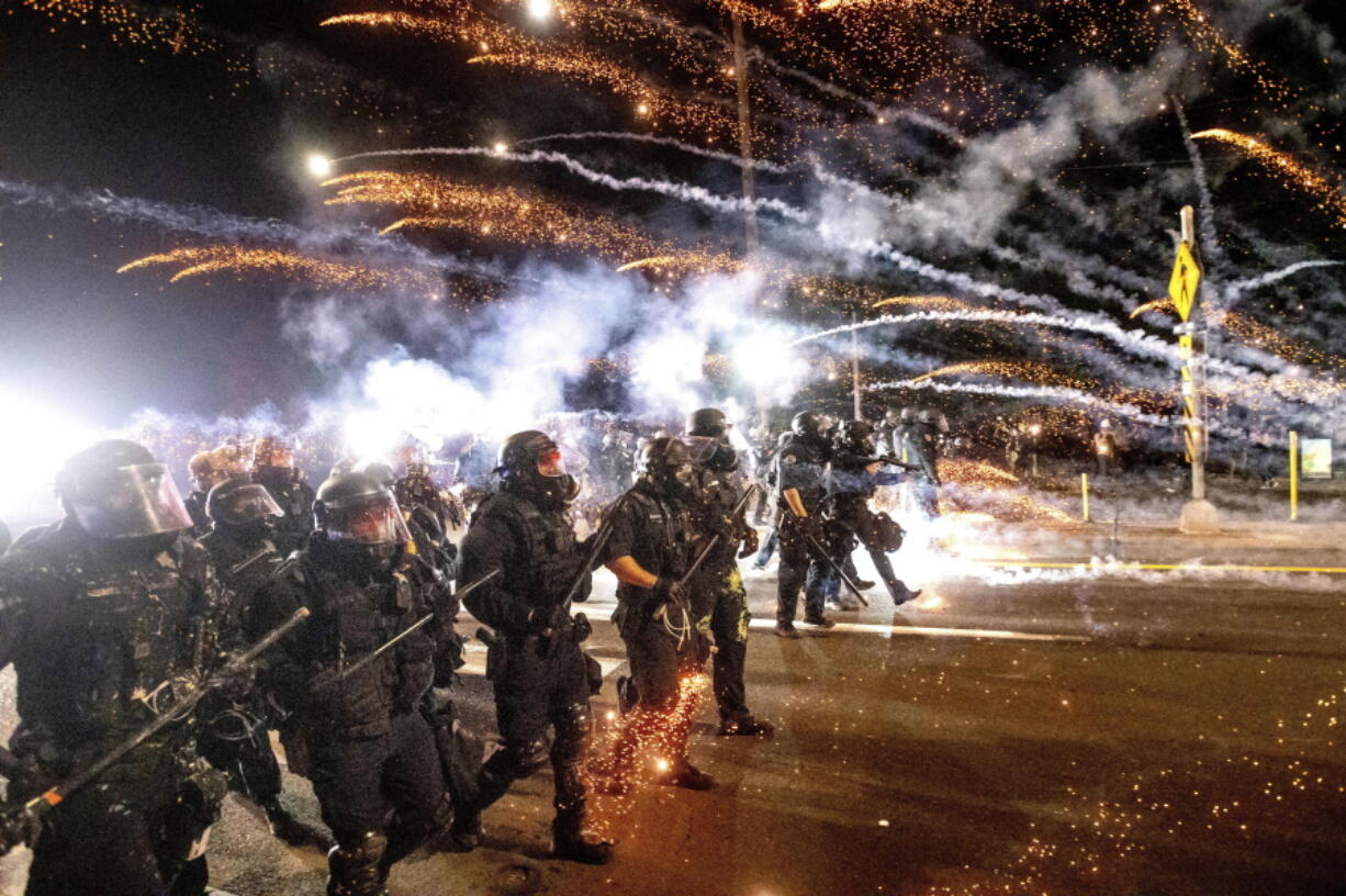 FILE - Police use chemical irritants and crowd control munitions to disperse protesters during a demonstration against police violence and racial injustice in Portland, Ore., Saturday, Sept. 5, 2020, sparked by the killing of George Floyd.