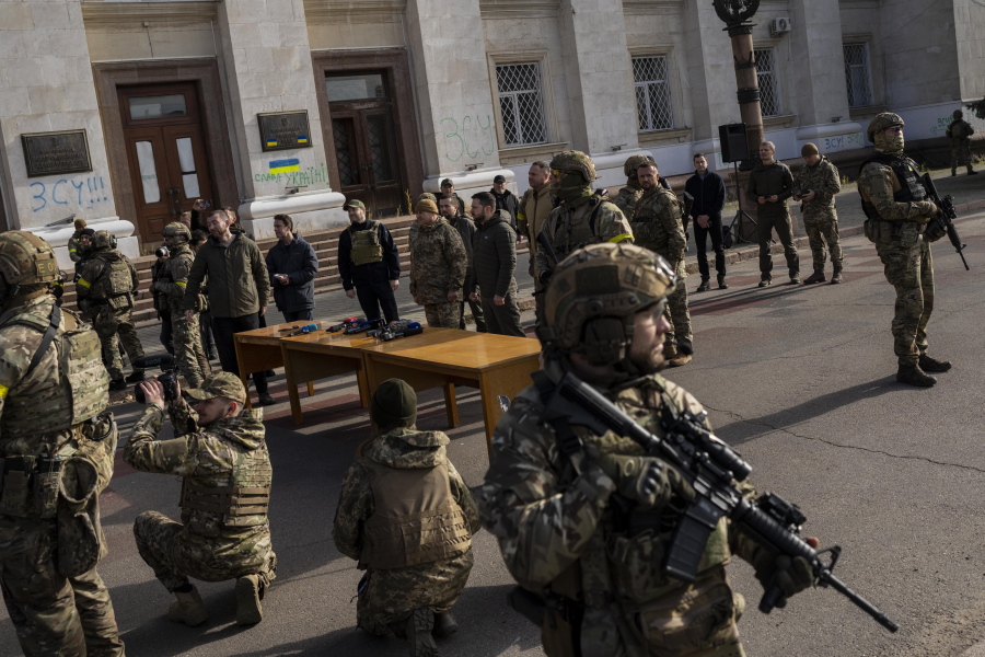 Ukrainian President Volodymyr Zelensky guarded by soldiers, gives a speech in Kherson, southern Ukraine, Monday, Nov. 14, 2022. Ukraine's retaking of Kherson was a significant setback for the Kremlin and it came some six weeks after Russian President Vladimir Putin annexed the Kherson region and three other provinces in southern and eastern Ukraine -- in breach of international law -- and declared them Russian territory.