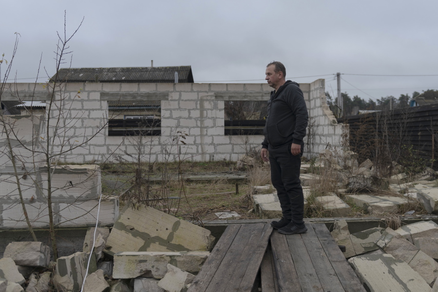 Vadym Zherdetsky stands Friday amid the wreckage of his house, which was destroyed by fighting in the village of Moshun, outside Kyiv, Ukraine. When Russia invaded in February, two missiles struck Zherdetsky's home, nearly killing four of his family members. More than half a year since Ukraine liberated Russian-occupied villages around Kyiv, people still are struggling to rebuild their lives.