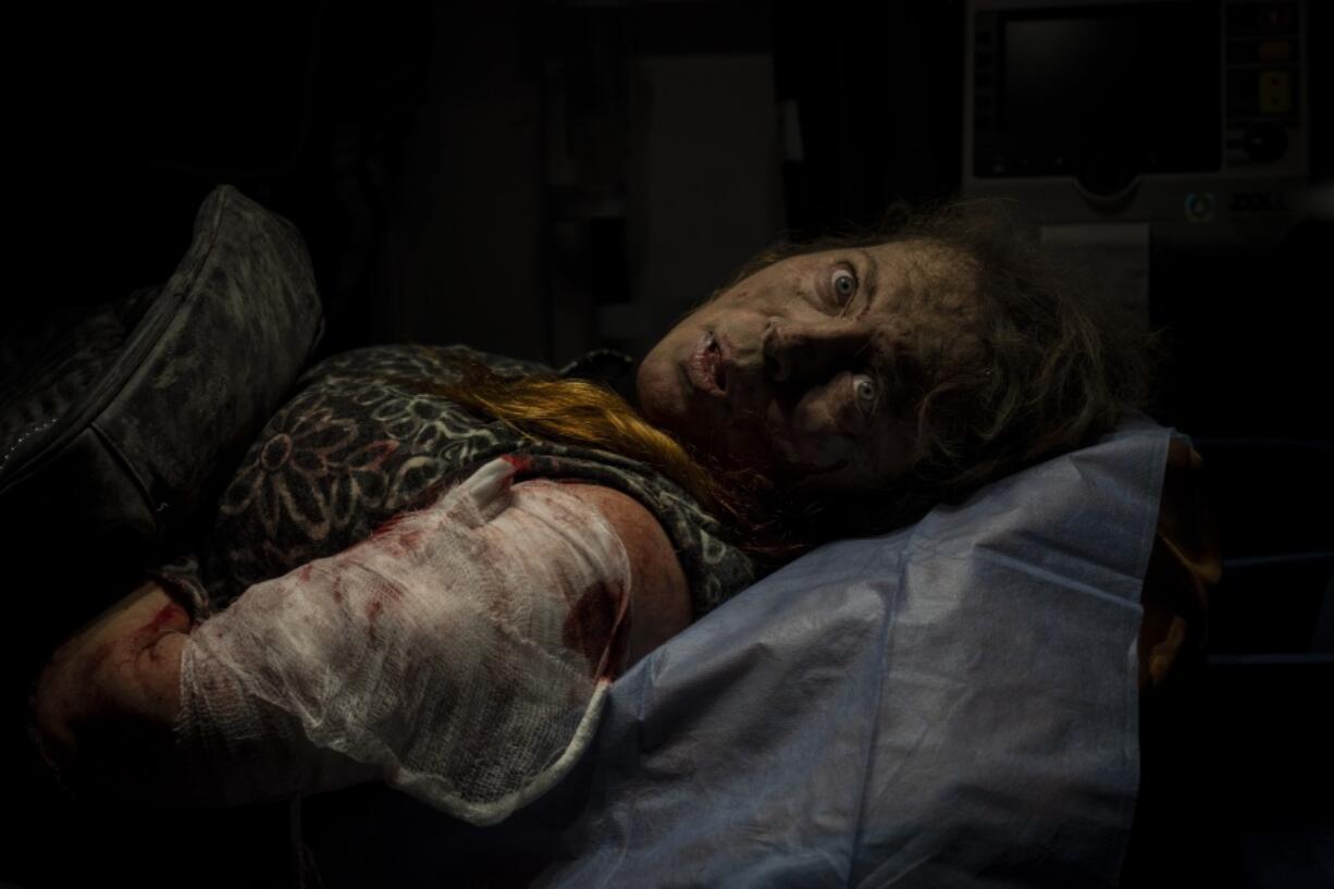 A resident wounded after a Russian attack lies inside an ambulance before being taken to a hospital in Kherson, southern Ukraine, Thursday, Nov. 24, 2022.