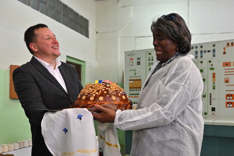 U.S. ambassador to the United Nations, Linda Thomas-Greenfield, right, is welcomed during her visit to the Kyiv Mlyn flour mill in Kyiv, Tuesday, Nov. 8, 2022. Thomas-Greenfield, reassured Ukrainian farmers Tuesday that it was a priority for the Secretary General to extend a wartime grain deal that allows Ukrainian grain and other commodities to be shipped to world markets.