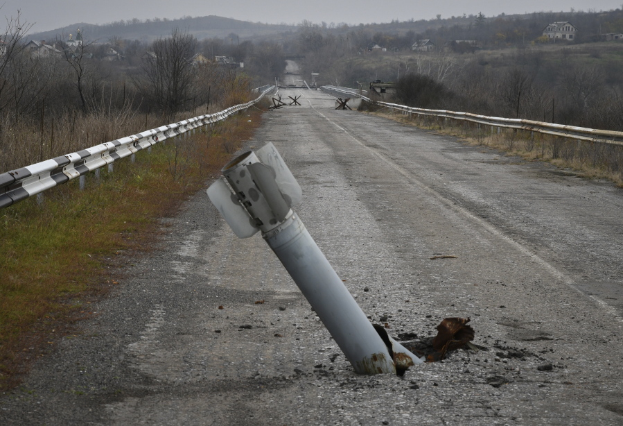 A tail of a multiple rocket sticks out of the ground near the recently recaptured village of Zakitne, Ukraine, Wednesday, Nov. 9, 2022. Villages and towns in Ukraine saw more heavy fighting and shelling Wednesday as Ukrainian and Russian forces strained to advance on different fronts after more than 8 1/2 months of war. At least nine civilians were killed and 24 others were wounded in 24 hours, the Ukrainian president's office said.