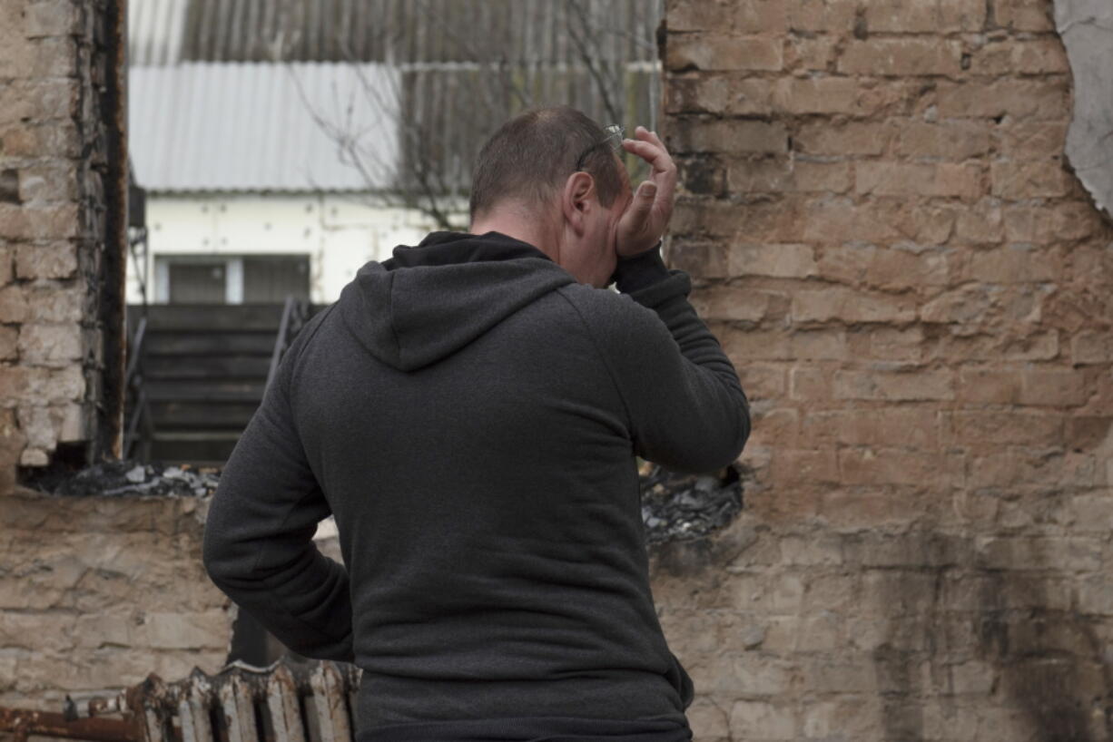 Vadym Zherdetsky reacts standing in the remains of his destroyed house, in the village of Moshun, outside Kyiv, Ukraine, Friday, Nov. 4, 2022.