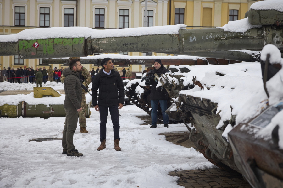 In this photo provided by the Ukrainian Presidential Press Office, Ukrainian President Volodymyr Zelenskyy, left, and British Prime Minister Rishi Sunak observe destroyed Russian military vehicles installed in downtown Kyiv, Ukraine, Saturday, Nov. 19, 2022.