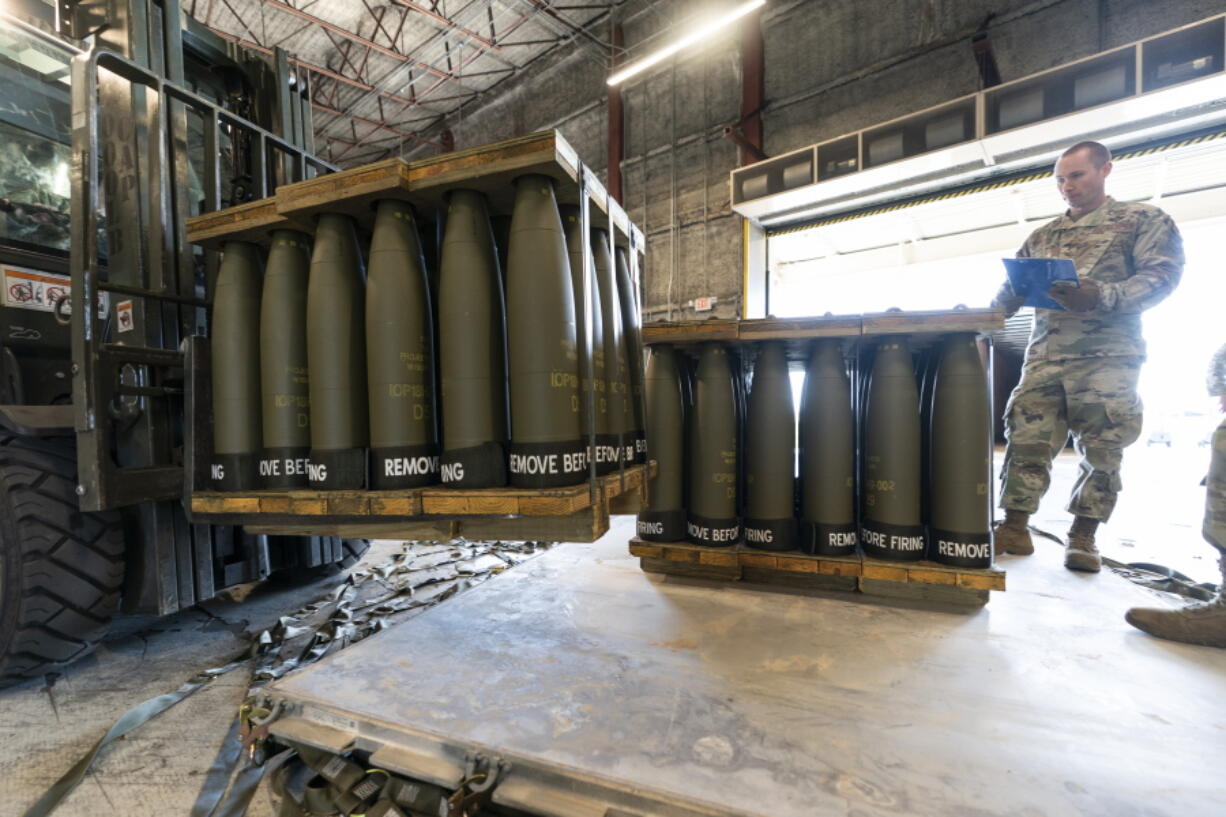 FILE - U.S. Air Force Staff Sgt. Cody Brown, right, with the 436th Aerial Port Squadron, checks pallets of 155 mm shells ultimately bound for Ukraine, April 29, 2022, at Dover Air Force Base, Del. The U.S. is sending another $400 million to Ukraine, pushing needed ammunition and generators to Ukraine from its own stockpiles, which will allow the aid to get to Ukraine faster than if the Pentagon procured the weapons from industry., getting needed heat and additional air defenses to Kyiv as winter sets in.