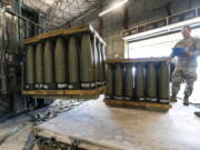 FILE - U.S. Air Force Staff Sgt. Cody Brown, right, with the 436th Aerial Port Squadron, checks pallets of 155 mm shells ultimately bound for Ukraine, April 29, 2022, at Dover Air Force Base, Del. The U.S. is sending another $400 million to Ukraine, pushing needed ammunition and generators to Ukraine from its own stockpiles, which will allow the aid to get to Ukraine faster than if the Pentagon procured the weapons from industry., getting needed heat and additional air defenses to Kyiv as winter sets in.