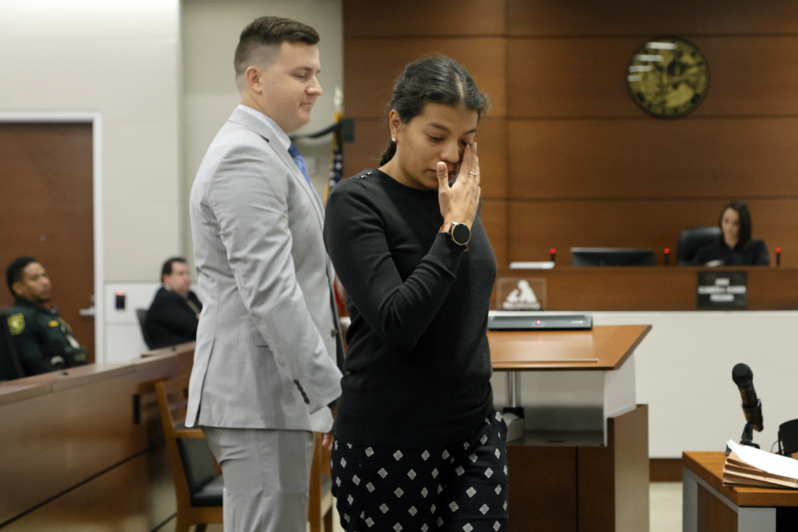 Ines Hixon, wipes away tears as she leaves the podium with her husband, Tommy Hixon, after she gave a victim impact statement during the sentencing hearing for Marjory Stoneman Douglas High School shooter Nikolas Cruz at the Broward County Courthouse in Fort Lauderdale, Fla. on Tuesday, Nov. 1, 2022. Tommy Hixon's father, Christopher, was killed in the 2018 shootings. Cruz was sentenced to life in prison for murdering 17 people at Parkland's Marjory Stoneman Douglas High School more than four years ago.