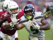 Seattle Seahawks running back Kenneth Walker III (9) runs against Arizona Cardinals linebacker Zaven Collins (25) during the second half of an NFL football game in Glendale, Ariz., Sunday, Nov. 6, 2022.