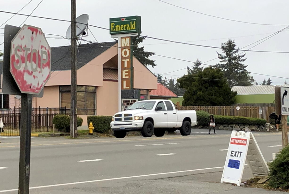Cars drive by the Emerald Motel in North Seattle on Friday, Nov. 11, 2022. Prosecutors say a 20-year-old woman made a harrowing escape from her vicious pimp outside the motel on the night of Saturday, Nov. 5, before being rescued by a ride-share driver who engaged in a gunfight with the man.