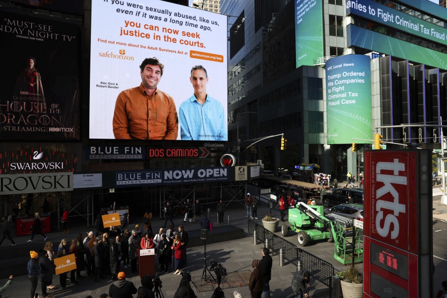 A Safe Horizon PSA about the Adult Survivors Act plays in Times Square during a press conference on the new law, Friday, Nov. 18, 2022, in New York. Sexual assault victims in New York will get a one-time opportunity to sue their abusers starting Thursday under a new law expected to bring a wave of litigation against prison guards, middle managers, doctors and a few prominent figures including former President Donald Trump.